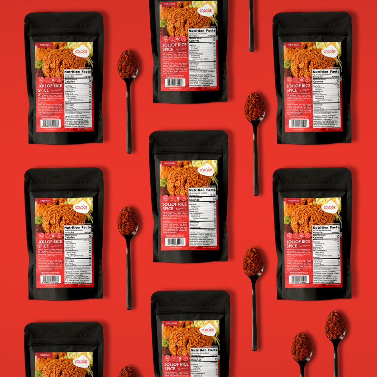 Pouches with labels of spices lay on red background surrounded by tea spoons full of red spice.
